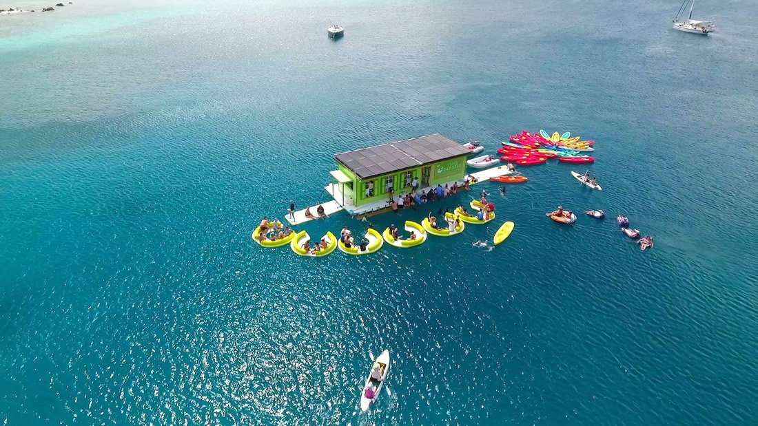 Boats anchored around a floating bar in turquoise water, Virgin Islands